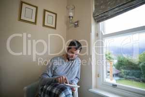 Man using digital tablet while sitting