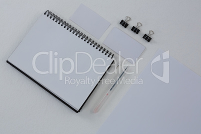 Book, paper clip, visiting cards and blank paper on white background