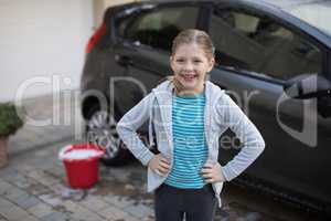 Teenage girl standing near the car