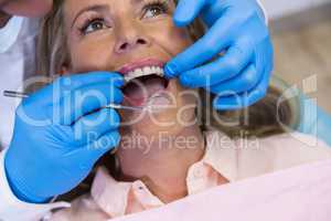 Dentist treating patient at medical clinic