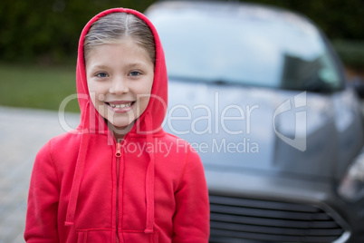 Teenage girl standing near the car