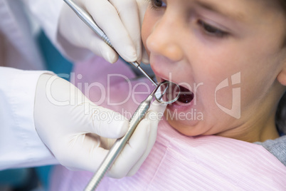 Dentist examining boy at clinic