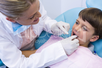 Female doctor examing boy mouth