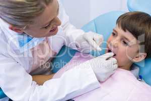 Female doctor examing boy mouth