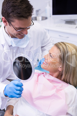 Doctor showing mirror to happy patient