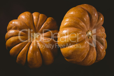 Close up of pumpkins against black background