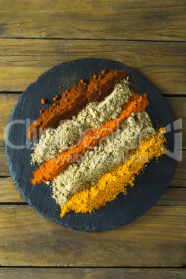 Various type of spice powder on slate plate