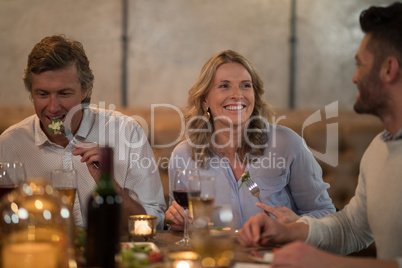 Friends interacting while dining in restaurant