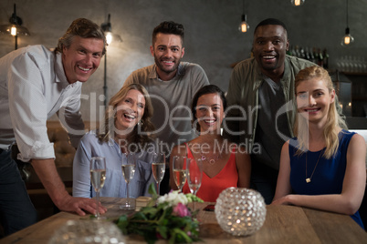 Portrait of friends sitting at dining table