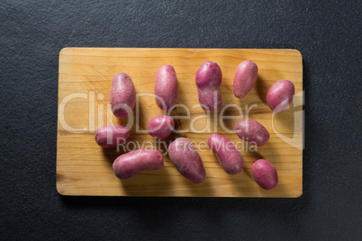 Overhead view of sweet potatoes on cutting board