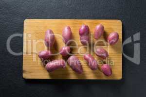 Overhead view of sweet potatoes on cutting board