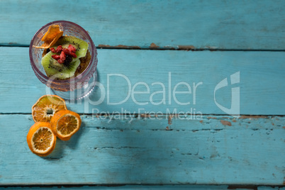 Kiwifruit slice and dried fruits in glass bowl with dried orange slice