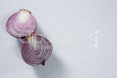 Halved onions on a white background