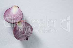 Halved onions on a white background