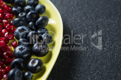 Close-up of blueberries with pomegranate seeds in plate