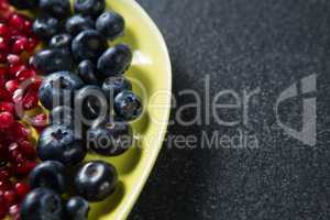 Close-up of blueberries with pomegranate seeds in plate