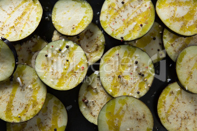 Slices of eggplant on a wooden table