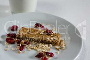 Granola bar in plate on white background