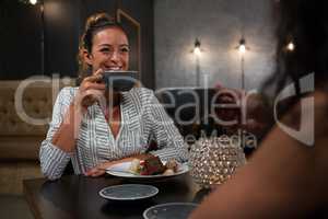 Beautiful woman interacting while having coffee