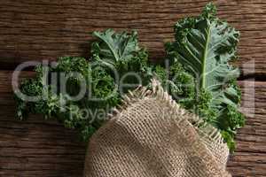 Wrapped mustard greens on wooden table