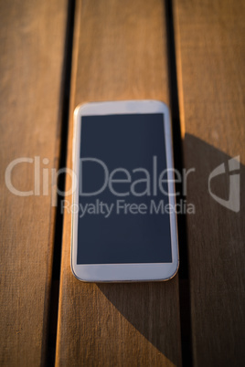 Mobile phone on wooden plank