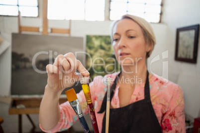 Woman painting in drawing book