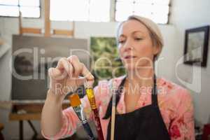 Woman painting in drawing book