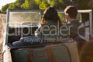 Rear view of couple in off road vehicle