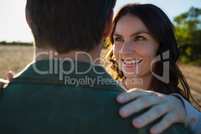 Happy woman looking at man on field Happy woman looking at man on field