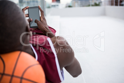 Basketball player using mobile phone