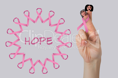 Composite image of cropped image of hand with pink breast cancer awareness ribbon