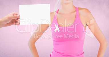Hand holding card with pink breast cancer awareness woman