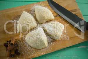 High angle view of raw cookies by knife on cutting board