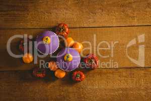 Overhead view of cup cakes with small pumpkins
