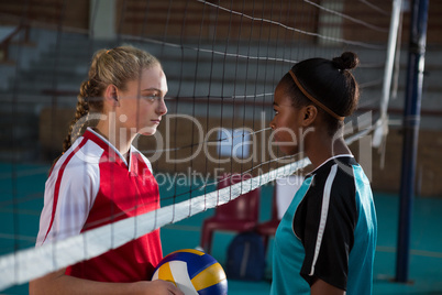 Volleyball players standing face to face