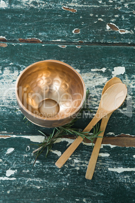 Golden steel bowl, spatula and spoon on table