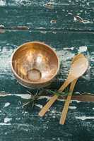 Golden steel bowl, spatula and spoon on table