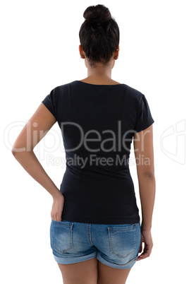 Rear view of young woman with hand in pocket