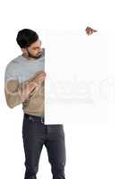 Handsome man looking at white blank sheet