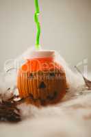 Close up of drink in jack o lantern container