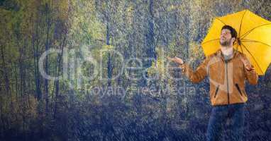 Man in Autumn with umbrella in forest of rain