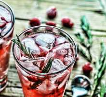 Fruity cocktail drink decorated with frozen raspberry