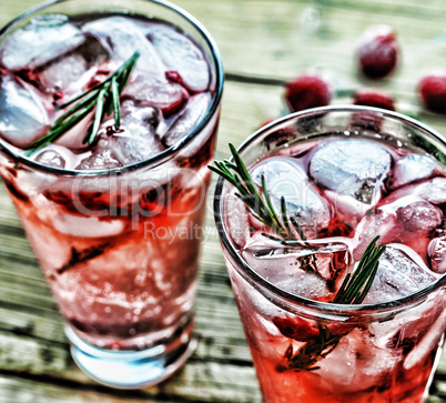 Fruity cocktail drink decorated with frozen raspberry