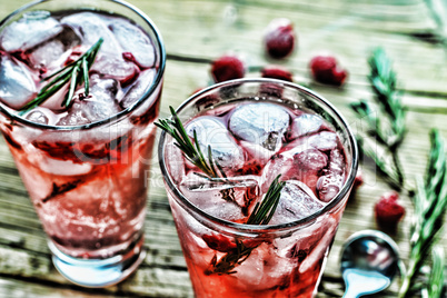 Fruity cocktail drink decorated with frozen raspberry