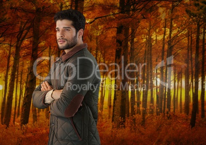 Man in Autumn with folded arms in forest