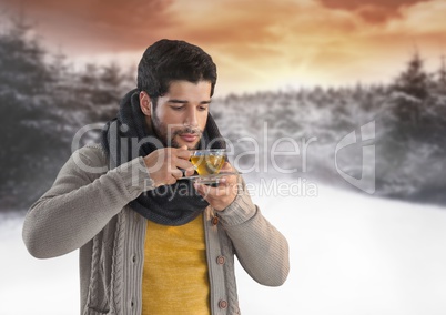 Man drinking tea in snow forest