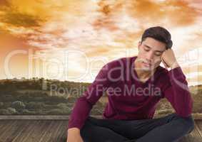 Man meditating over landscape