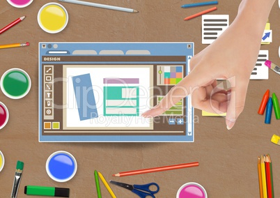 Hand touching Design editor window and creative art objects on Paper cut out desktop