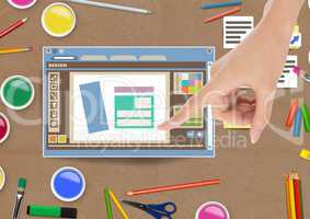 Hand touching Design editor window and creative art objects on Paper cut out desktop