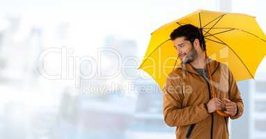 Man with yellow umbrella and bright background